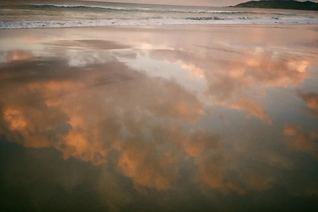 photo of sky reflected on sand