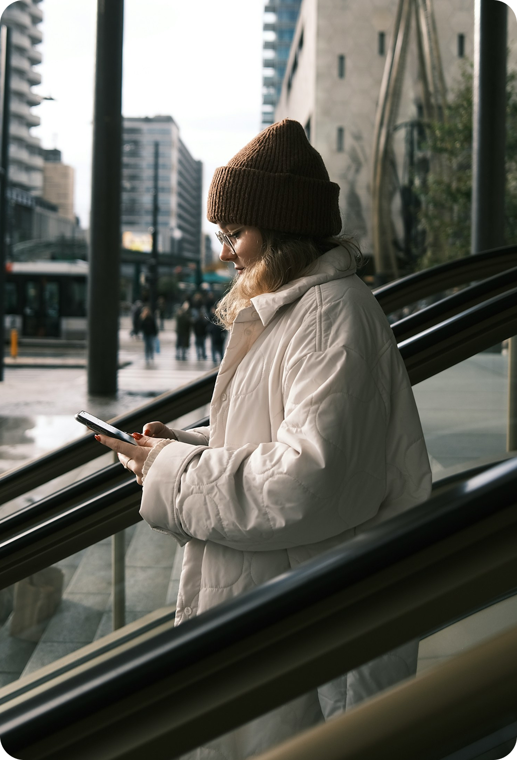 A person using the Gabby Coaching app on their phone while out in the city